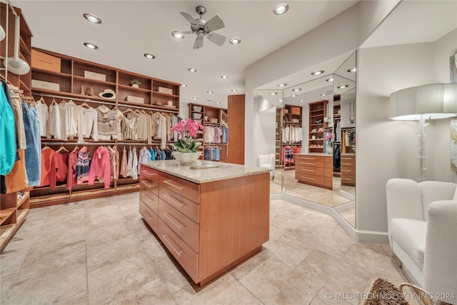 walk in closet with ceiling fan