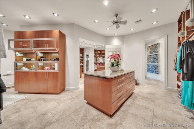 kitchen with recessed lighting, visible vents, and light stone countertops