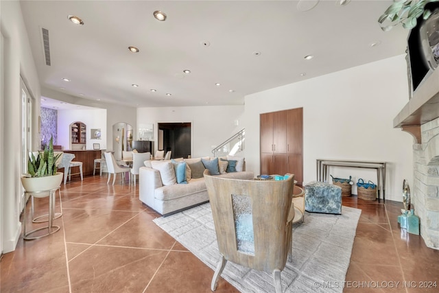 living room featuring recessed lighting, a fireplace, and light tile patterned floors