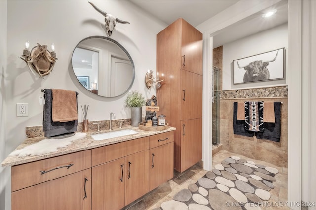 bathroom featuring a high end fireplace, a stall shower, and vanity