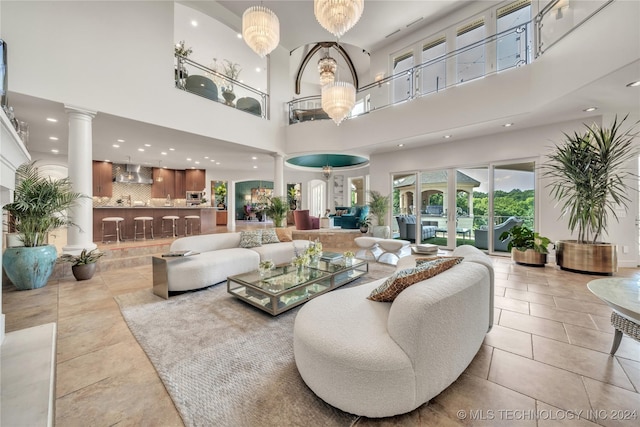 living room featuring recessed lighting, decorative columns, and tile patterned floors