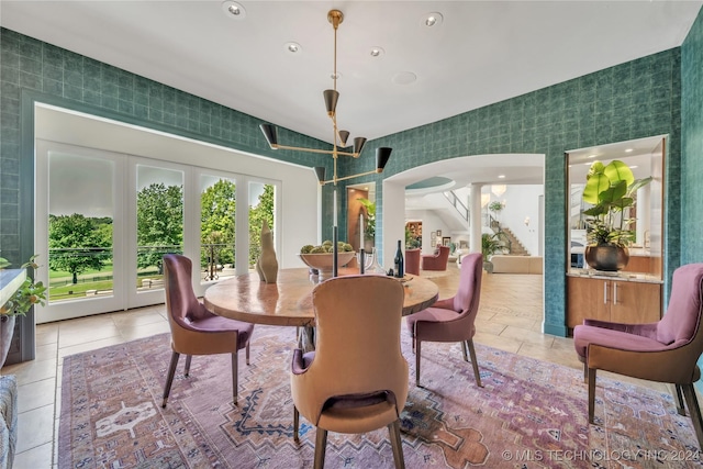 dining area with arched walkways, light tile patterned floors, and recessed lighting