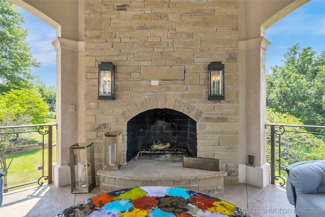 exterior details featuring stone siding and an outdoor stone fireplace