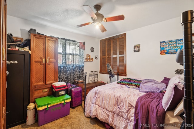 carpeted bedroom featuring a textured ceiling, a closet, and ceiling fan