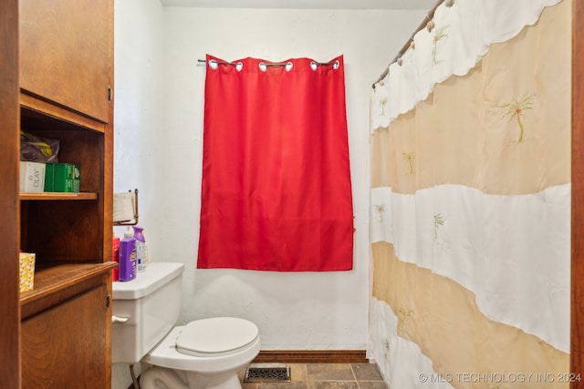 bathroom with tile patterned floors and toilet