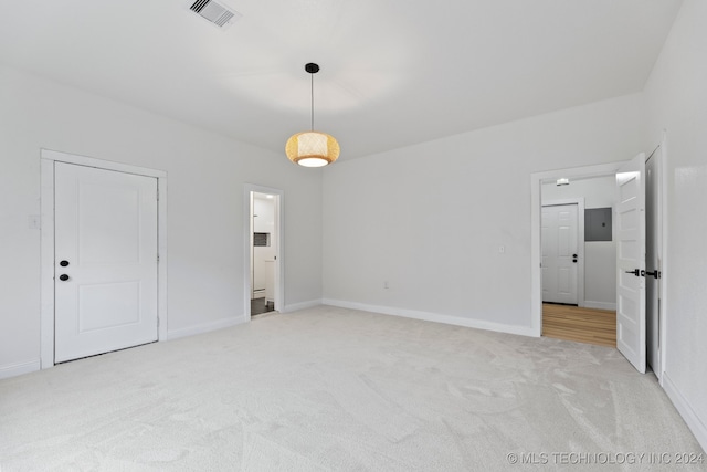 spare room with electric panel and light colored carpet