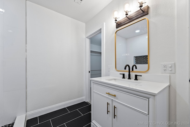 bathroom featuring tile patterned flooring and vanity