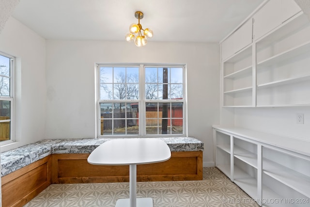 interior space featuring breakfast area, a notable chandelier, and tile patterned floors