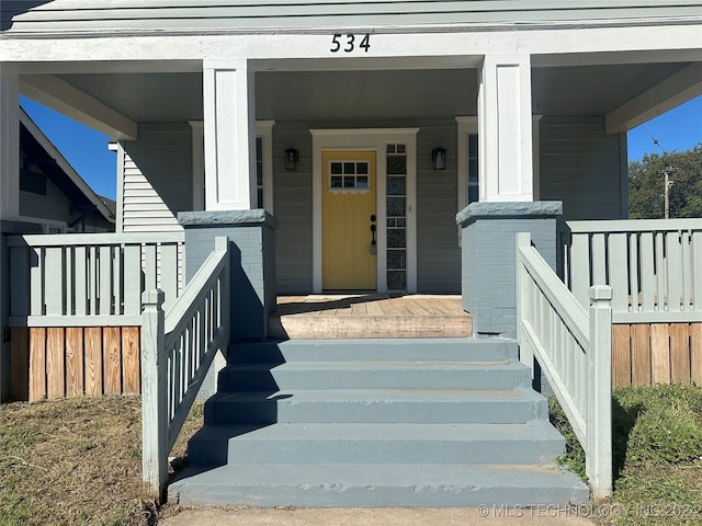 view of exterior entry featuring a porch