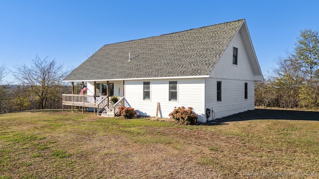 back of house with a lawn and a porch