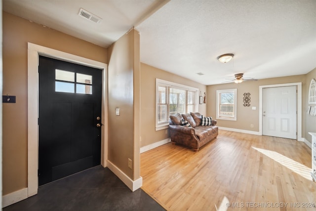 entryway featuring ceiling fan, a textured ceiling, and hardwood / wood-style flooring