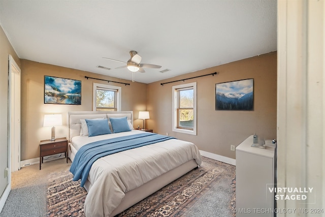 bedroom featuring carpet flooring, multiple windows, and ceiling fan