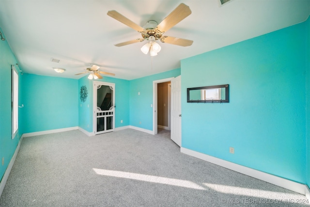 interior space featuring ceiling fan and light carpet