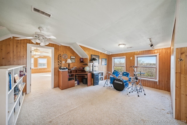 playroom with wood walls, lofted ceiling, crown molding, and light carpet