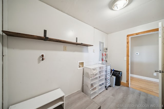 interior space with hookup for a washing machine and light hardwood / wood-style floors