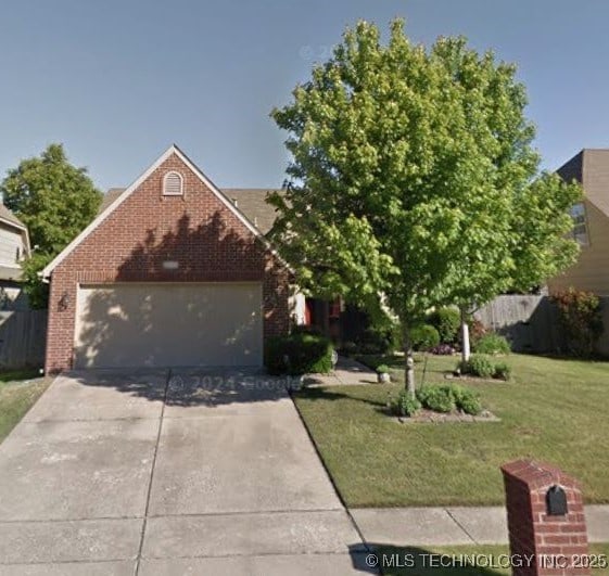 view of front of property with a garage and a front yard