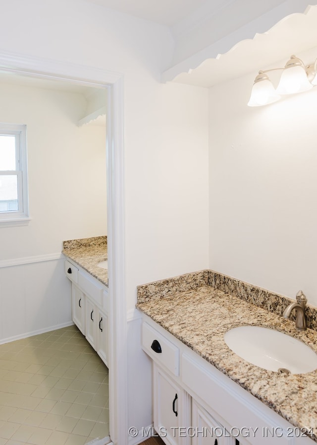 bathroom with tile patterned flooring and vanity