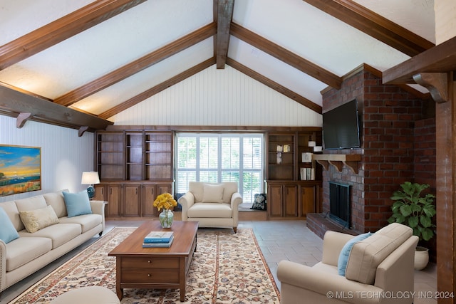 living room featuring beamed ceiling, a fireplace, and high vaulted ceiling