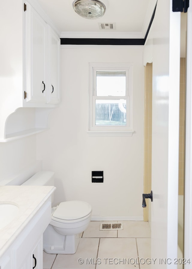 bathroom featuring tile patterned flooring, vanity, toilet, and ornamental molding