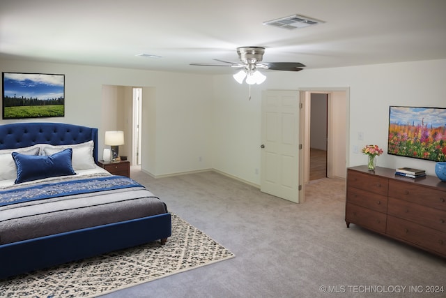 bedroom with ceiling fan and light carpet