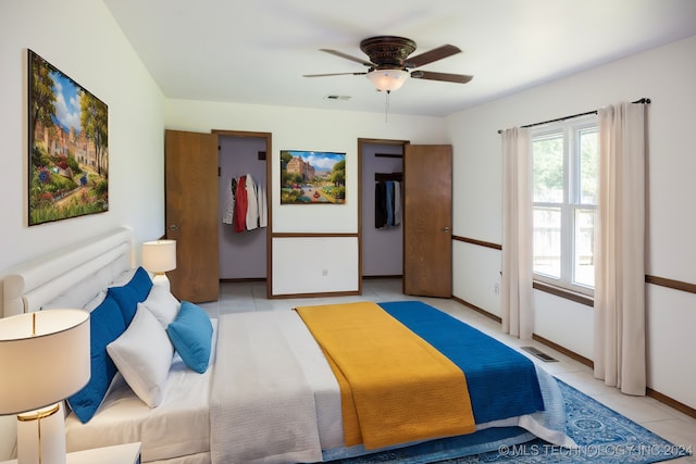 bedroom with ceiling fan and light tile patterned floors