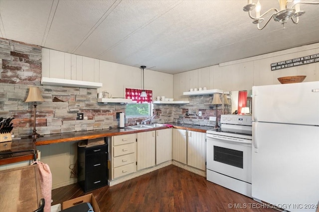 kitchen featuring white appliances, dark wood-type flooring, decorative backsplash, range hood, and decorative light fixtures