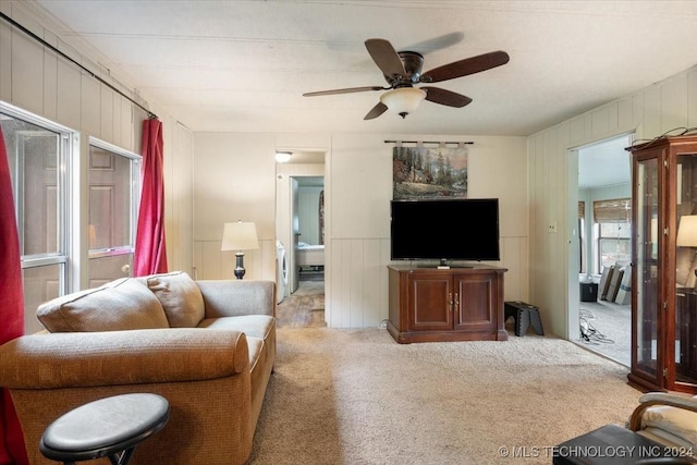 carpeted living room with ceiling fan