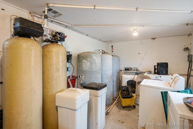 clothes washing area featuring separate washer and dryer