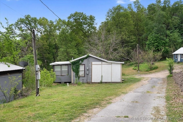 view of outbuilding featuring a lawn