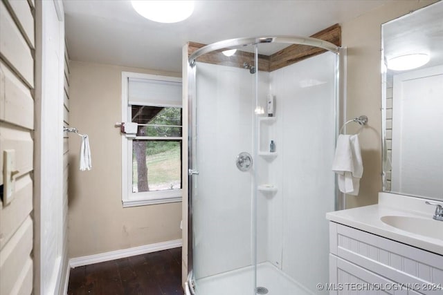 bathroom with vanity, hardwood / wood-style flooring, and a shower with shower door