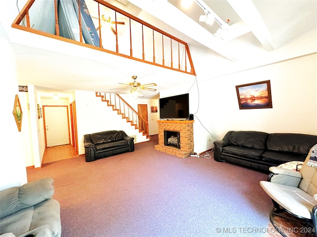 carpeted living room featuring ceiling fan, a fireplace, and rail lighting