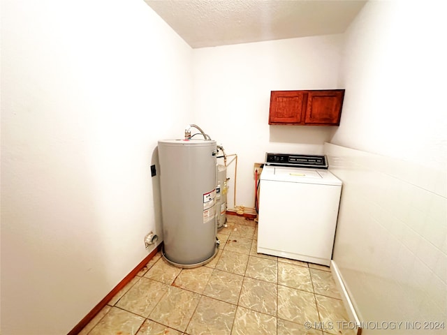 washroom featuring light tile patterned flooring, water heater, washer / clothes dryer, and cabinets