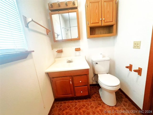 bathroom with vanity, tile patterned flooring, and toilet