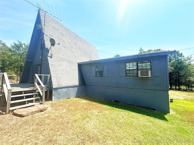 view of property exterior with a yard and cooling unit