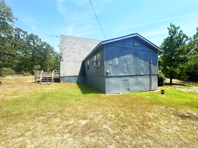 view of side of property featuring a deck and a yard