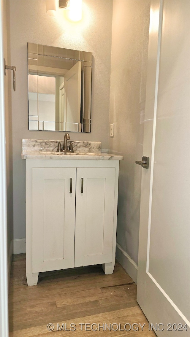 bathroom with vanity and hardwood / wood-style floors