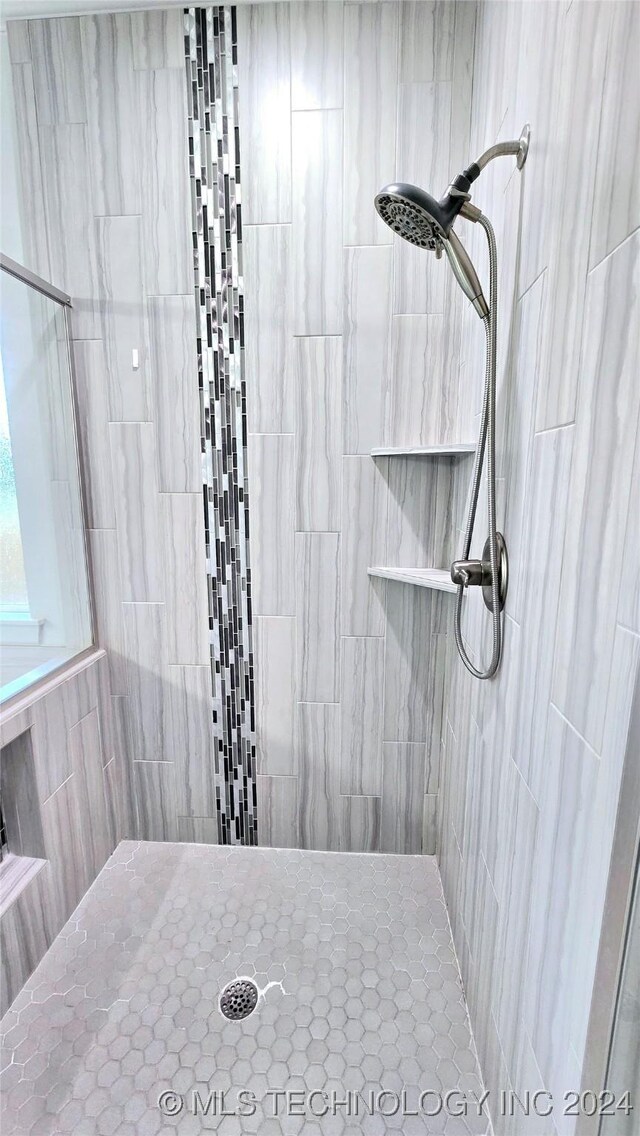 bathroom with a tile shower