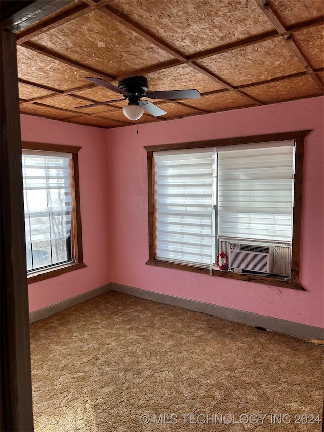 carpeted spare room featuring cooling unit and ceiling fan