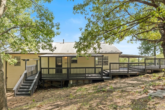 back of house with a wooden deck