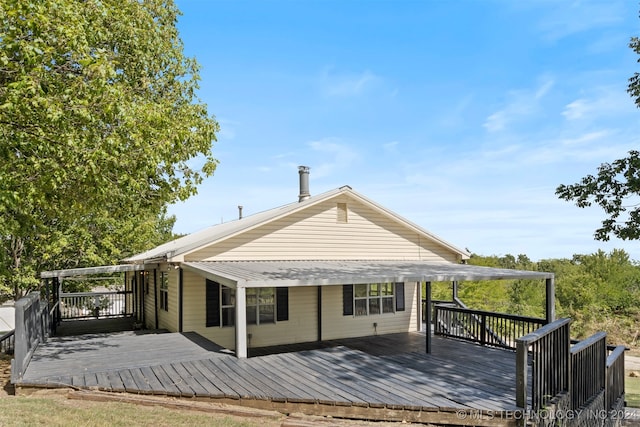 rear view of property featuring a deck