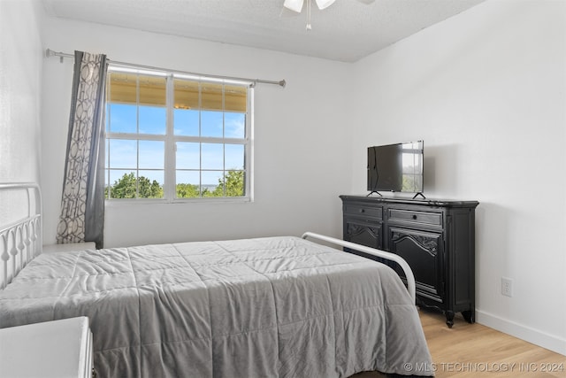 bedroom with ceiling fan and light hardwood / wood-style floors