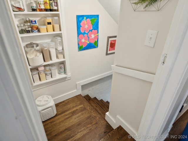 interior space with baseboards and wood finished floors