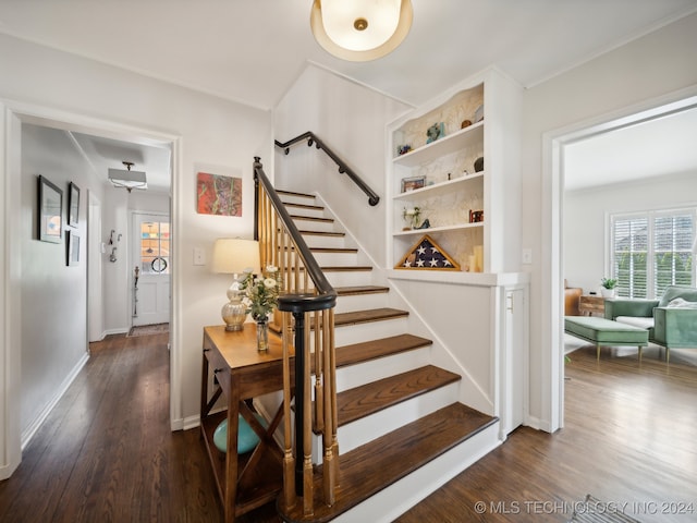 stairway featuring crown molding, wood finished floors, and baseboards