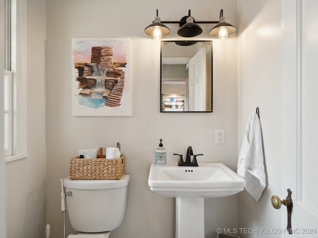 half bathroom with toilet and a sink