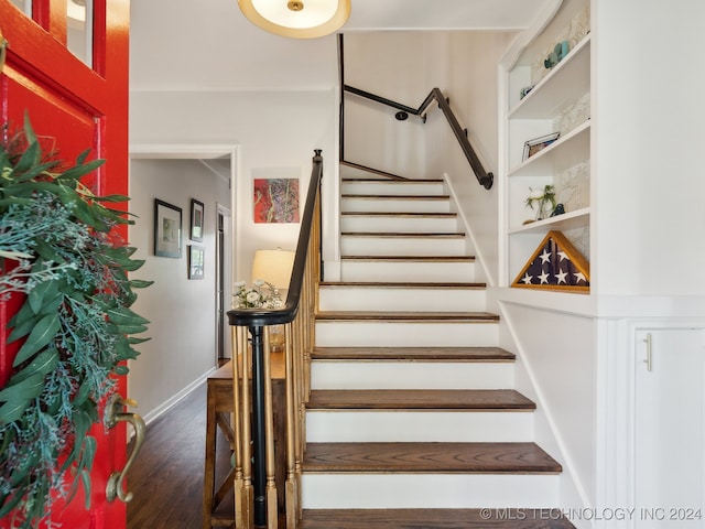 stairs featuring baseboards and wood finished floors