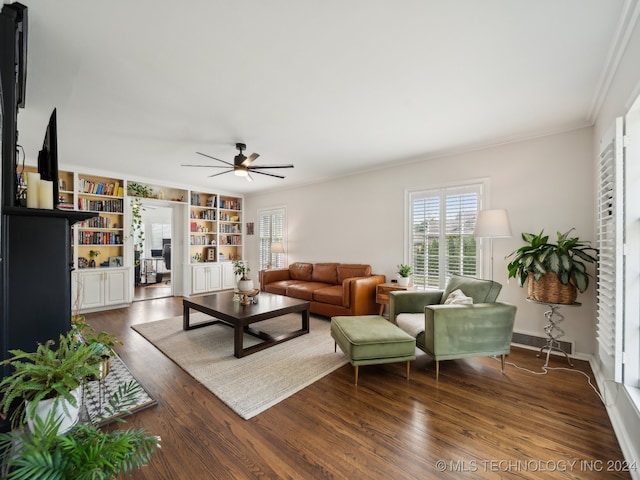 living area featuring dark wood-style floors, ornamental molding, a ceiling fan, and baseboards