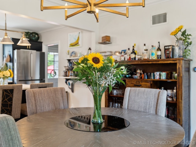 dining space with ornamental molding and visible vents