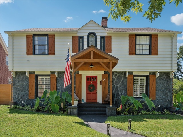 view of front of property with a front lawn and a chimney