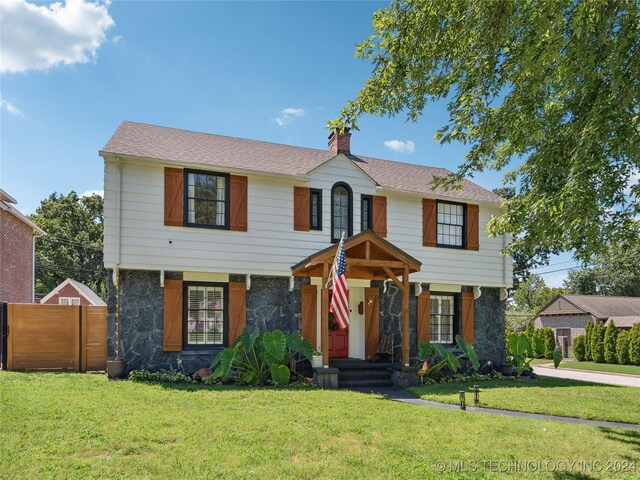 colonial home with a front lawn