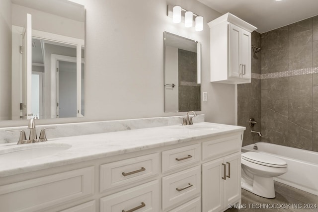 full bathroom featuring tiled shower / bath, toilet, and vanity